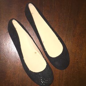 Black velvet flats with gold embellishments.